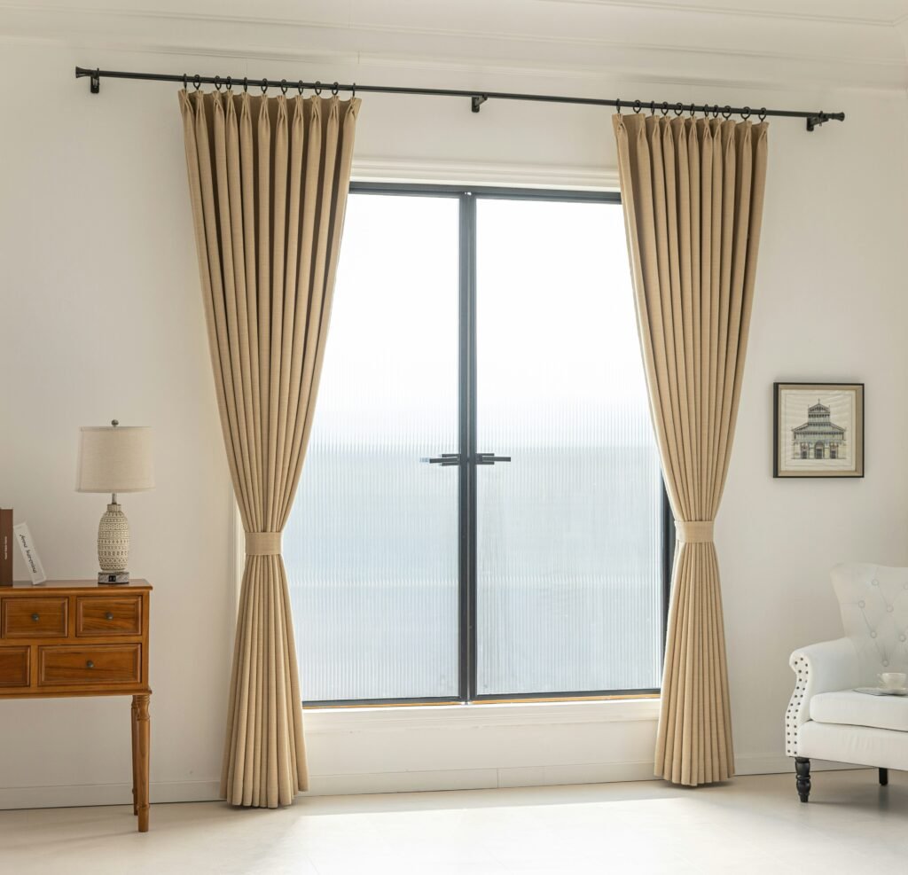 Elegant beige curtains framing window